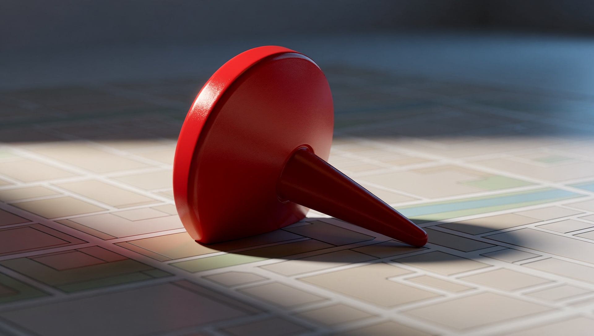 Toppled red map pin lying on a city map, symbolizing a ranking drop
